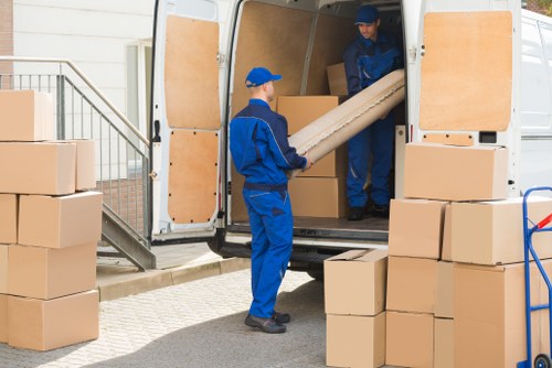 House removals planning in Colindale with packed boxes and moving van